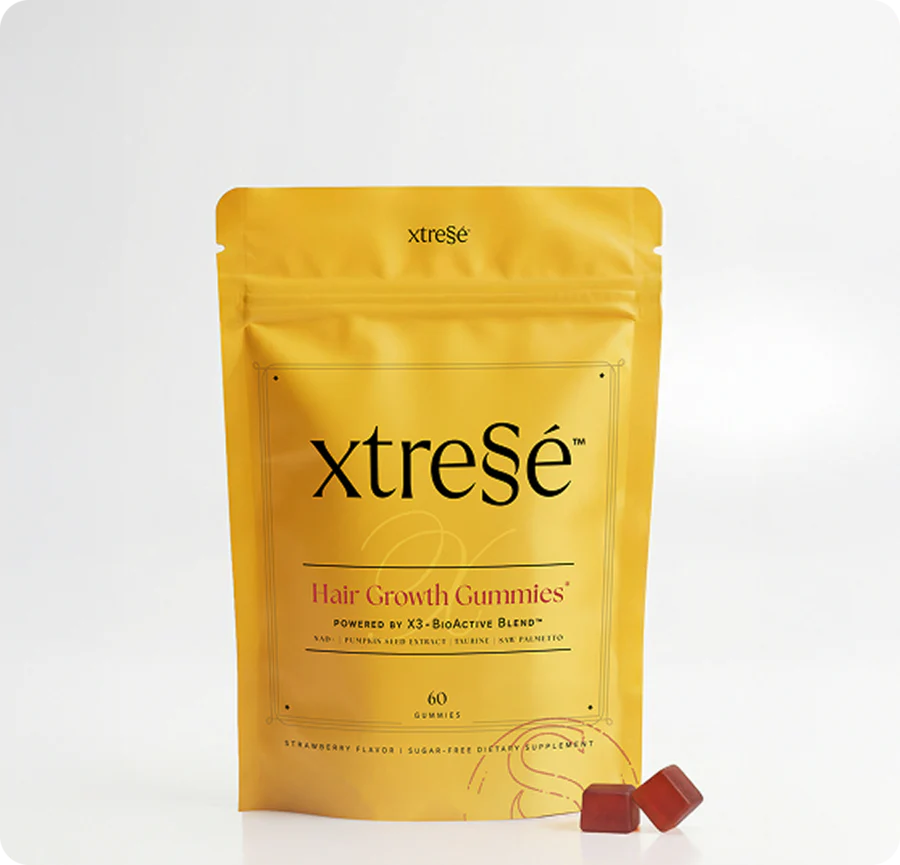 Yellow xtreSé Hair Growth Gummies pouch on a white background with two red gummies beside it